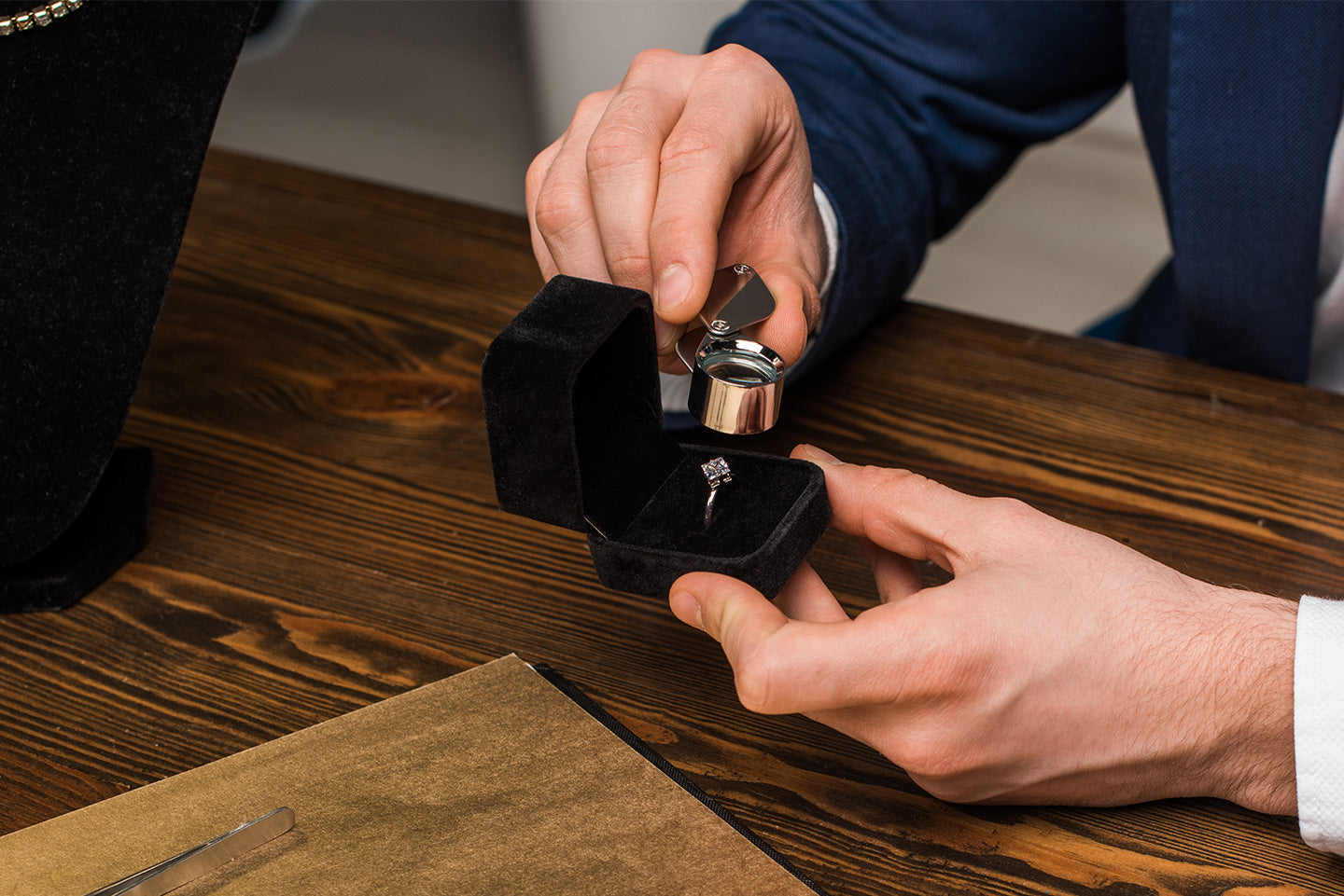 A man uses a magnifier to view lab-grown vs. natural diamonds